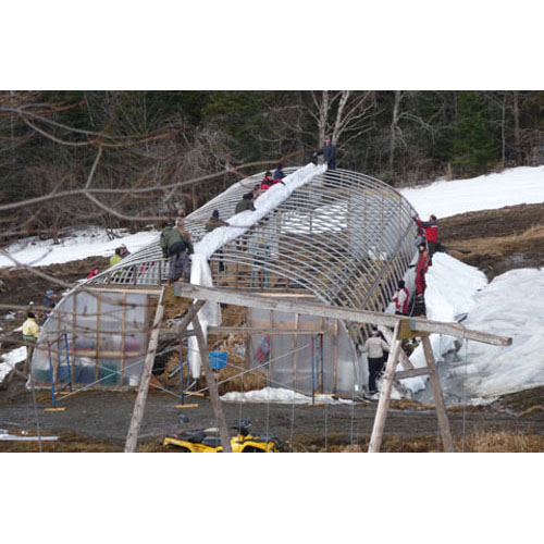 Getting together to replace the plastic cover that was ripped by the wind